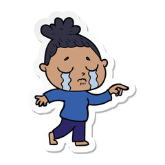 sticker of a cartoon crying woman pointing