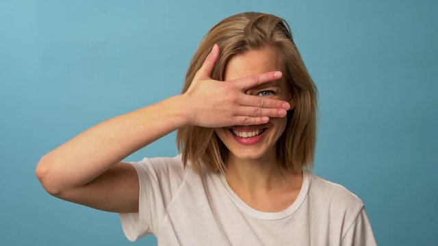 model with blonde hair cover eyes with both hands