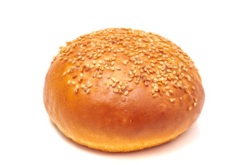 Hamburger bun with sesame seeds isolated on white background