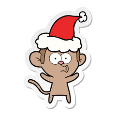 sticker cartoon of a surprised monkey wearing santa hat