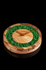 Wooden clock with color stabilized moss on a black background with mirror otgruzheniya. Trend 2019. Wall Clock. copy space