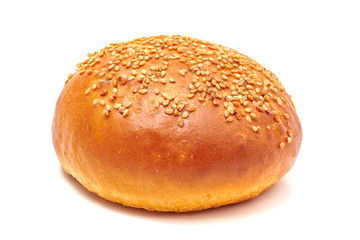 Hamburger bun with sesame seeds isolated on white background
