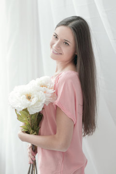 lovely young woman with a bouquet of peonies.photo with copy space