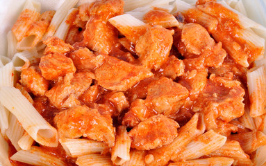 goulash with meat pieces and pasta close up.