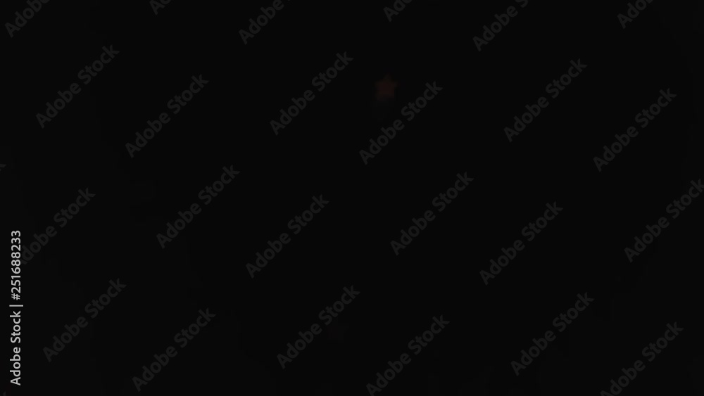 Poster bokeh in the shape of stars and blur of fireworks exploding at night in the sky