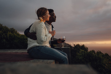 Interracial couple admiring the sunset