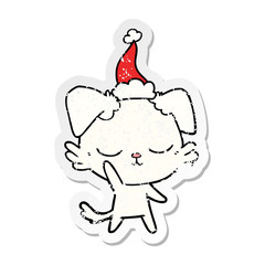 cute distressed sticker cartoon of a dog wearing santa hat