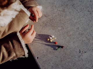 Little girl playing with bombs, colorful firecrackers