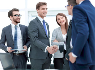 colleagues shaking hands in office