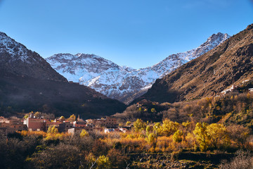 View of the valley in High Atlas mountains Africa with Jebel Toubkal mountain in background during sunrise