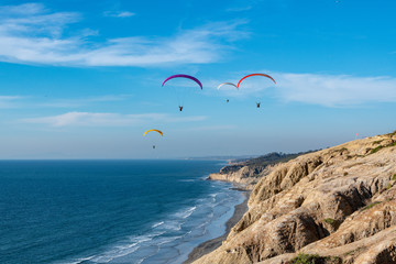 paragliders over the sea