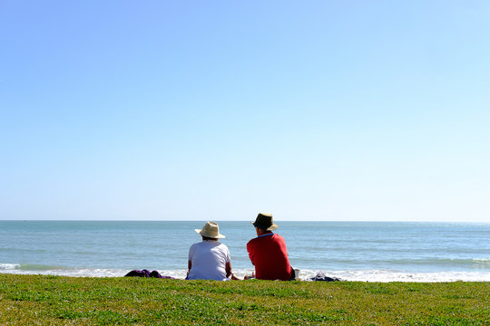 A mature couple gazing the sea in Algarve.