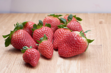 close up fresh strawberries with natural wood background