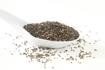 chia seeds Salvia hispanica in spoon on white background