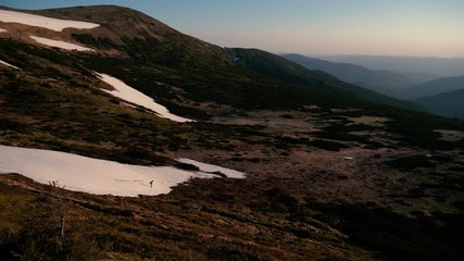 A lonely mountain climber goes down in the Carpathians in autumn in slo-mo.