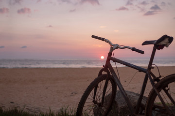 Fototapeta na wymiar Bike on the beach, sea, sunset.