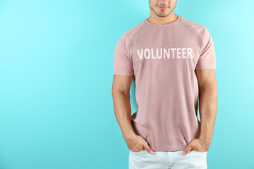 Young man in t-shirt on color background. Mockup for design