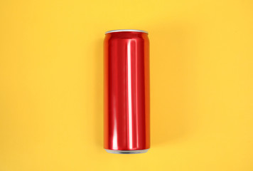 Blank metal red can on color background, top view. Mock up for design