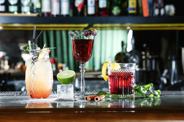 Fresh alcoholic cocktails in glasses on bar counter