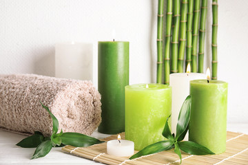 Beautiful spa composition with green candles on table