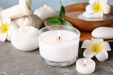 Beautiful spa composition with candles and flowers on table