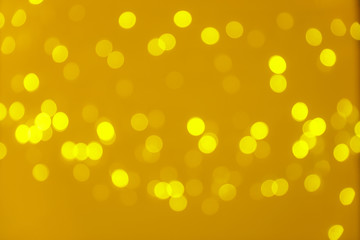 Blurred view of shiny gold lights. Bokeh effect