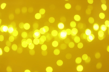 Blurred view of shiny gold lights. Bokeh effect