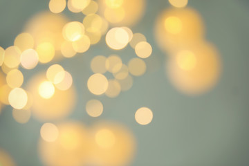 Blurred view of shiny gold lights. Bokeh effect