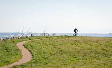 The silhouette of the cyclist on road bike at midday Sport and active life concept sunset time. A...