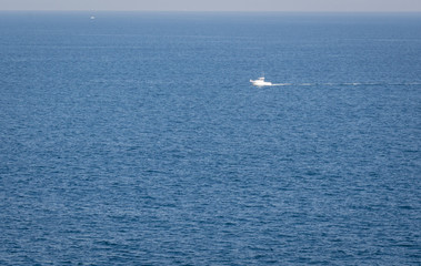 Minimal view of the Cantabrian sea Morning seascape with a lonely boat floating in the middle of the sea