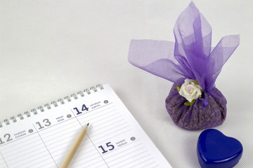 planner and pencil on a white background with a fragrant lavender package