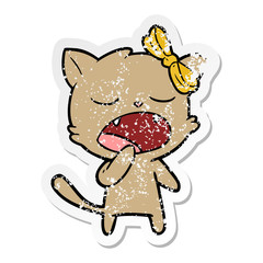 distressed sticker of a cartoon yawning cat