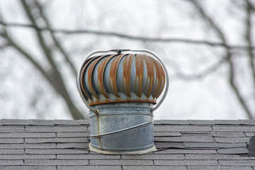 A rusty turbine style roof vent