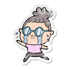 distressed sticker of a cartoon crying woman wearing spectacles
