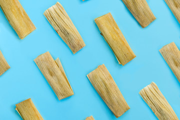 Colorful pattern with tamales on blue background. Top View. Copy Space. Pop art design.