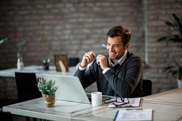 Happy businessman working on a computer in the office.