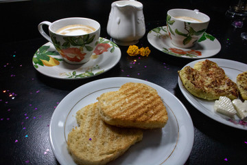 Breakfast on Valentine's Day - fried omelete, bread, apple and White cheese in the shape of a heart  coffe and milk. 