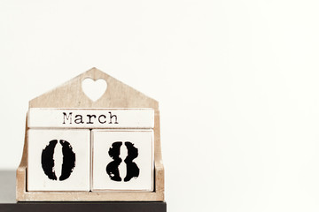 March 8 on a calendar on a desk iand white copy space. Holiday concept