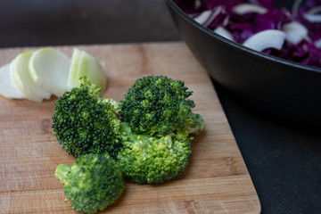 Cut broccoli florets on wooden board