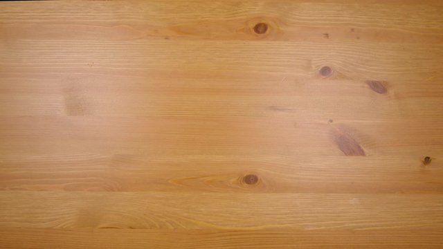 Hand removes a plate berries, strawberries, blueberries, blackberries and raspberries from a wooden table in 4k.