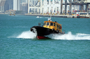 Fototapeta premium Miami,Florida based Pilot Boat heading out to sea to guide a container ship into the Port of Miami