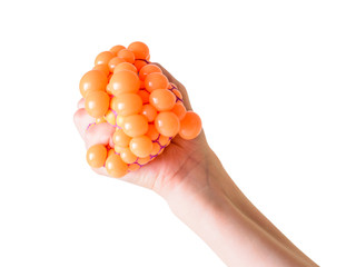 The child's hands squeeze bubbles out of the toy against stress isolated on a white background.