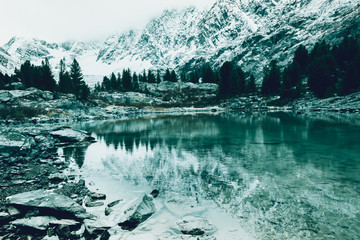 Mountain lake, rocks are reflected in water surface