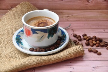 Obraz na płótnie Canvas Fresh coffee beans on wood and gunny sack