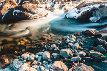 Fast mountain river. Water among stones