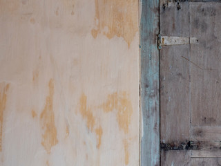 Background, texture of old plaster and painted wood. shutters on the facade