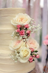 Close up cream wedding cake with flowers