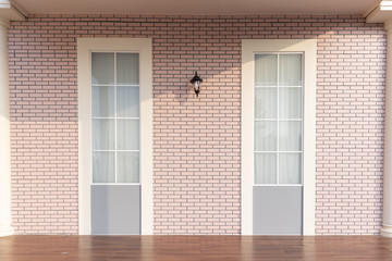 Fototapeta premium empty wooden floor with soft pink brick wall.