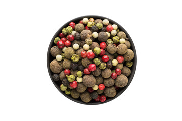 Mixture of peppers hot, red, black, white and green pepper in clay bowl isolated on white background. Seasoning or spice top view