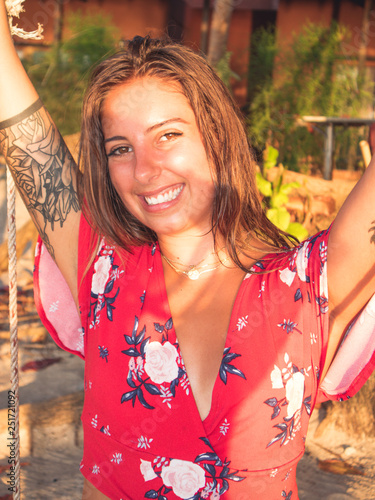 A Beatiful Hispanic Young Woman Swinging On A Swing By The